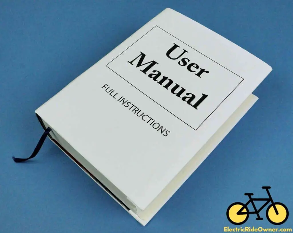 White hardcover book with User Manual written in bold letters with box containing words and Full Instructions written in smaller letters below box on a blue background