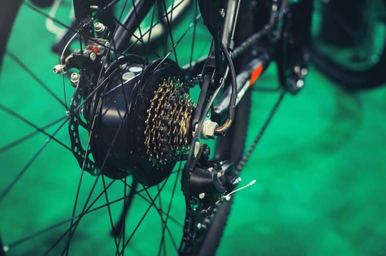 close up of rear wheel hub motor on ebike wheel with green background