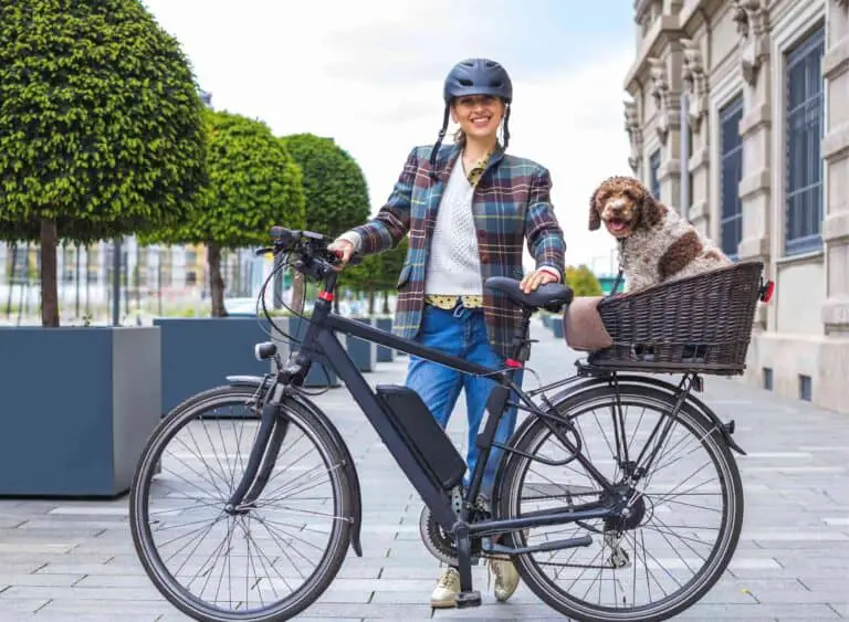 woman holding ebike with a dog