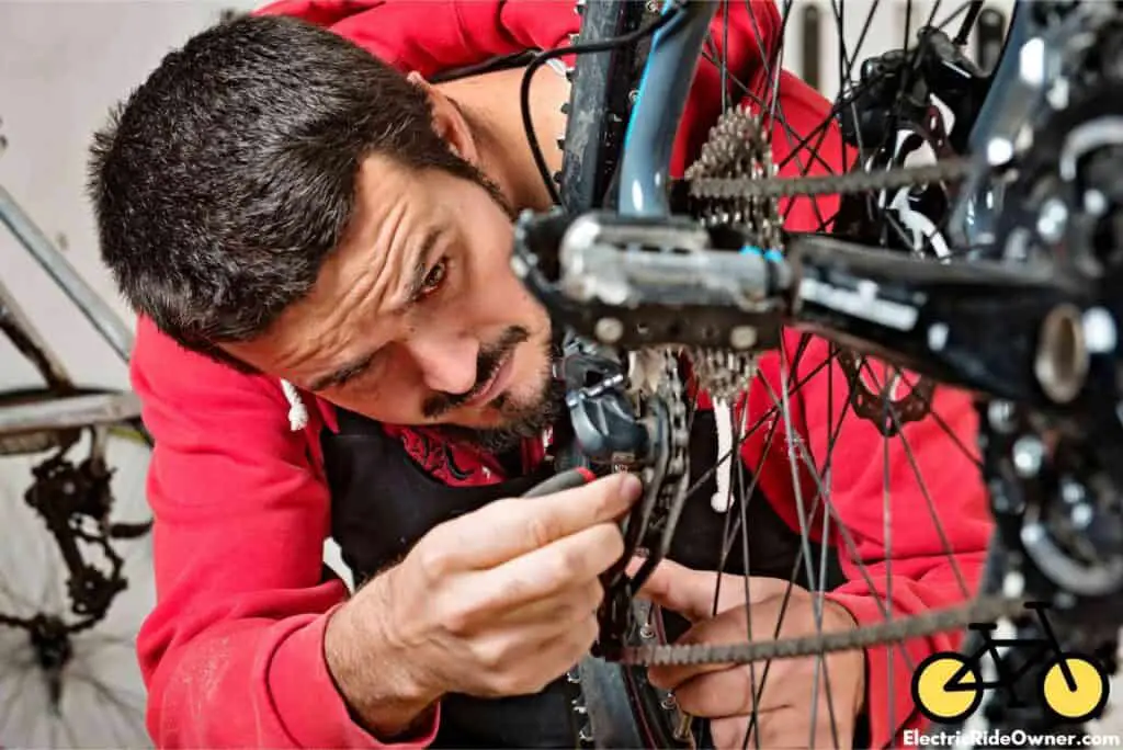 mechanic cleaning an e-bike