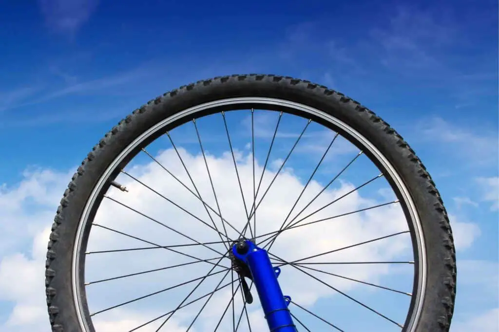 Bike wheel against blue sky as background