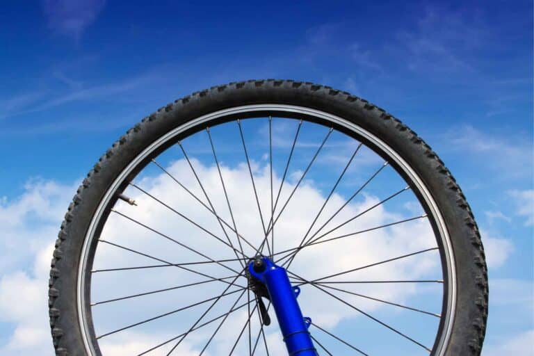 Bike wheel against blue sky as background