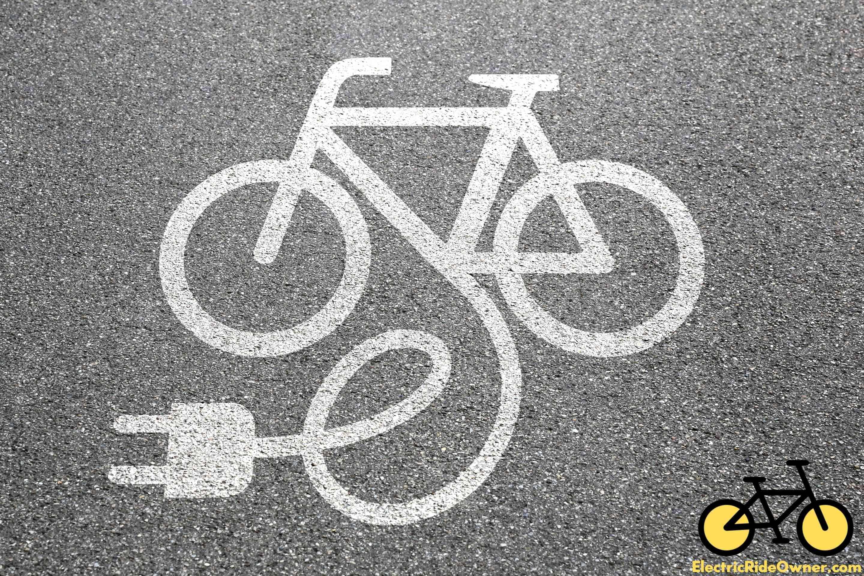 electric bike charging sign stamped on pavement