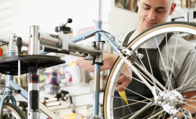 man repairing e-bike at bike shop