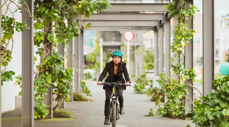 woman with helmet riding e-bike