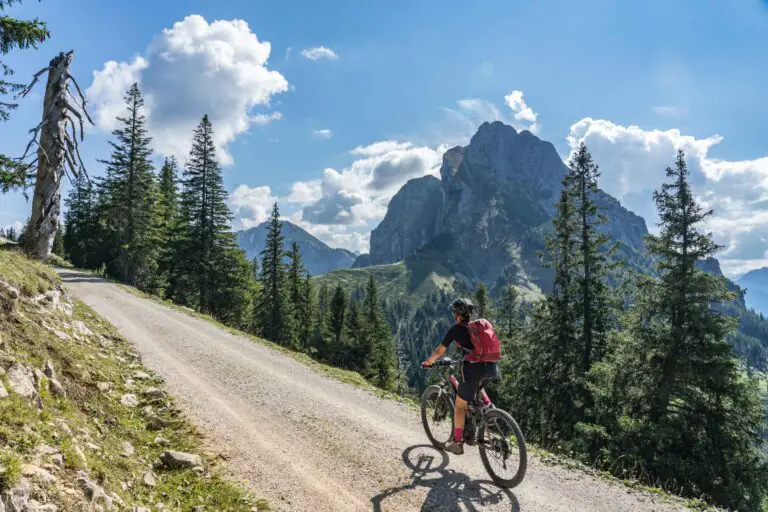 a woman riding an e-bike on a mountain