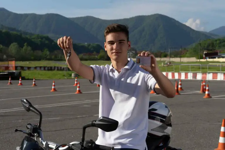 young man holding a key and license